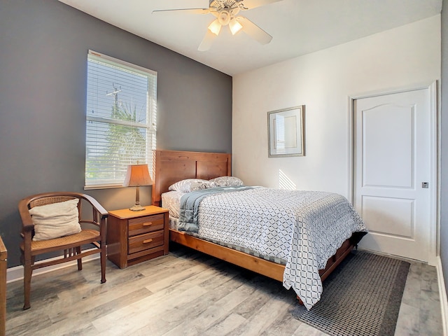 bedroom with ceiling fan and light wood-type flooring