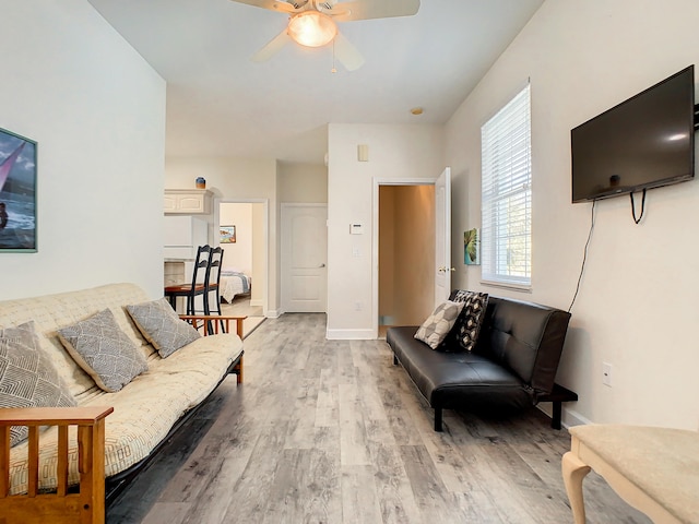 living room with hardwood / wood-style flooring and ceiling fan