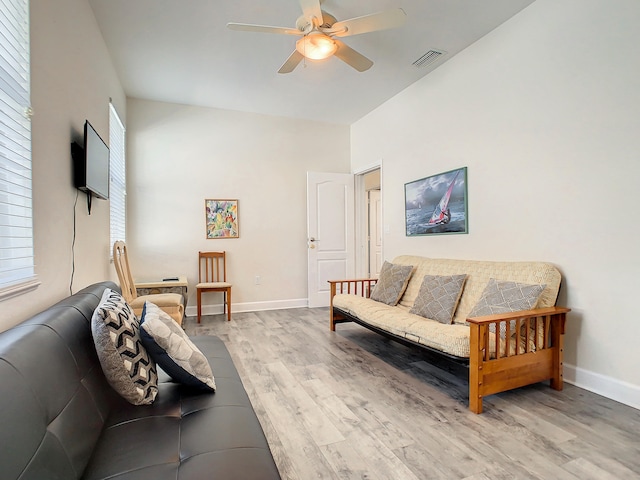 living room with wood-type flooring and ceiling fan