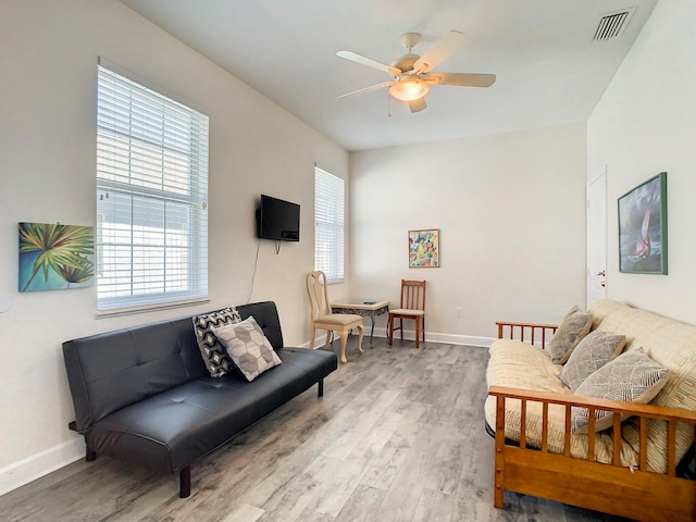 living room featuring hardwood / wood-style flooring and ceiling fan