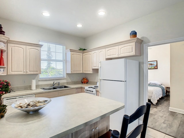 kitchen featuring white appliances, light hardwood / wood-style flooring, and sink