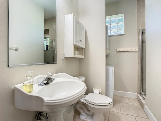 bathroom featuring tile patterned flooring, toilet, and an enclosed shower