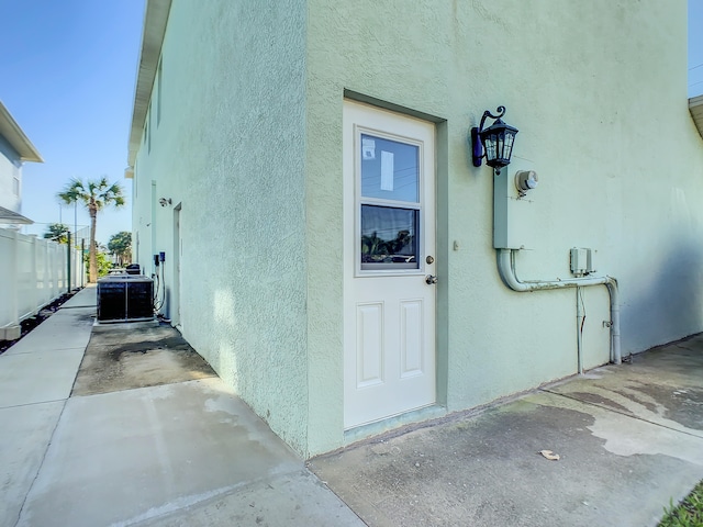 doorway to property featuring central AC unit