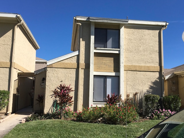 view of property exterior featuring a lawn