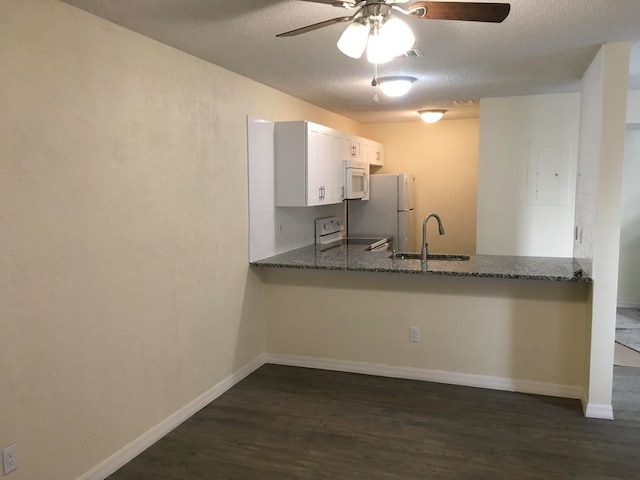 kitchen featuring ceiling fan, white appliances, white cabinets, dark hardwood / wood-style floors, and sink