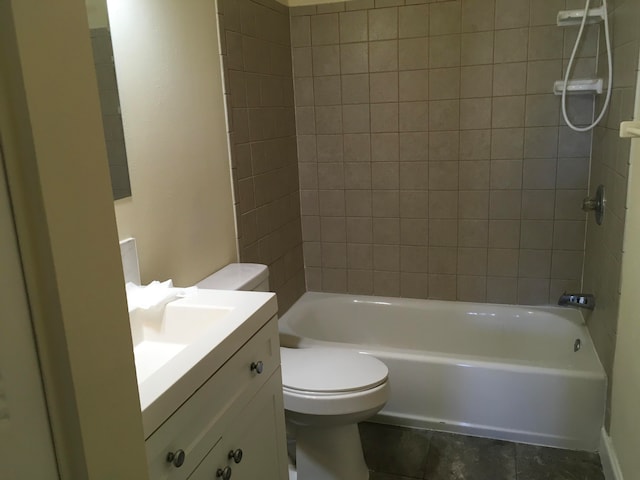 full bathroom featuring tiled shower / bath, toilet, tile floors, and large vanity