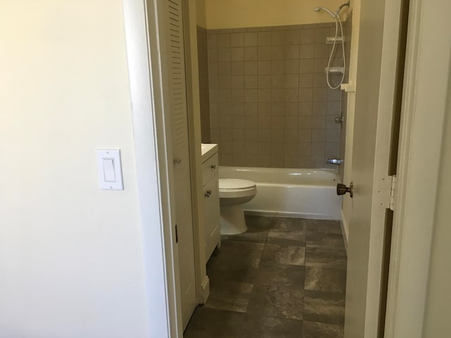 full bathroom featuring vanity, tile flooring, toilet, and tiled shower / bath