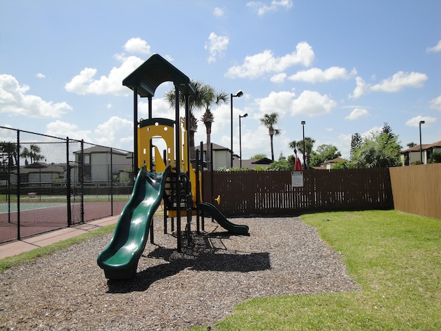 view of playground with a lawn