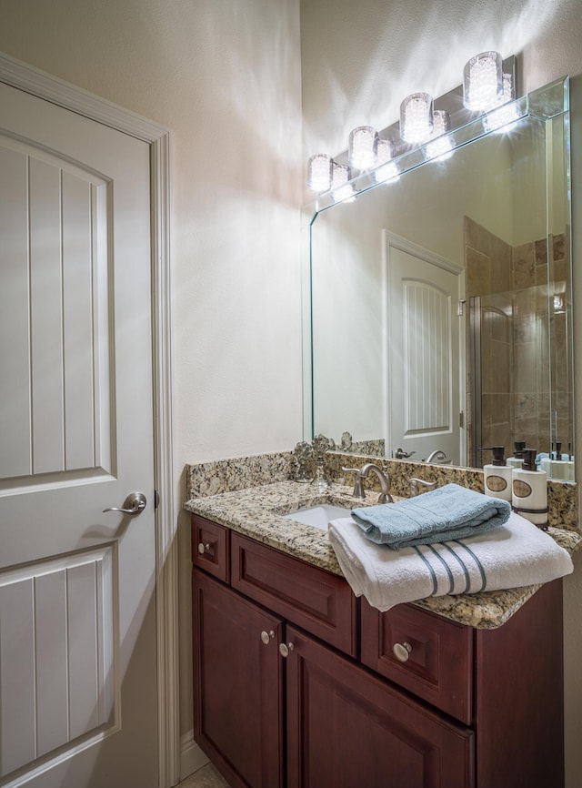 bathroom featuring an enclosed shower and vanity