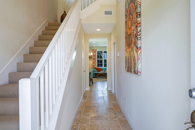 staircase featuring light tile flooring