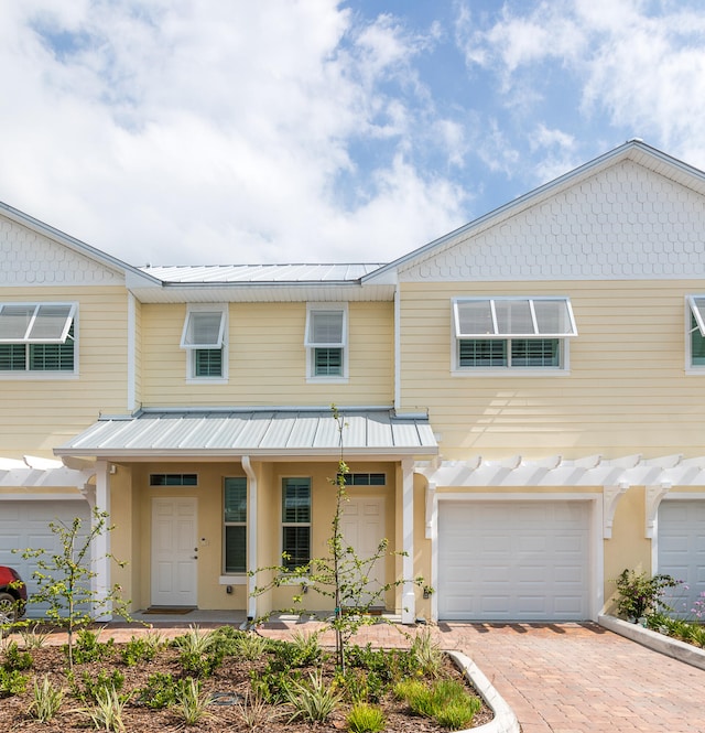 multi unit property featuring a garage