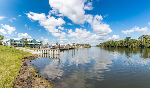 dock area featuring a lawn and a water view