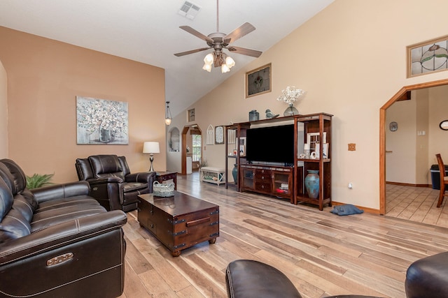 tiled living room featuring high vaulted ceiling and ceiling fan