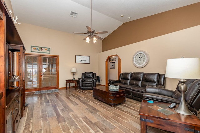 living room featuring lofted ceiling, ceiling fan, light hardwood / wood-style flooring, and french doors