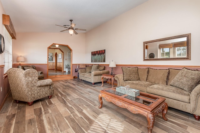 living room with high vaulted ceiling, ceiling fan, and dark hardwood / wood-style flooring