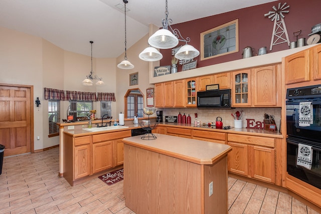 kitchen featuring decorative light fixtures, black appliances, high vaulted ceiling, sink, and a kitchen island