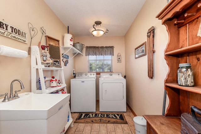 laundry area with washer and clothes dryer and sink