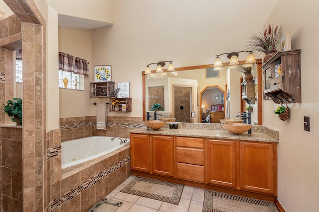 bathroom with a relaxing tiled bath, tile flooring, and double vanity