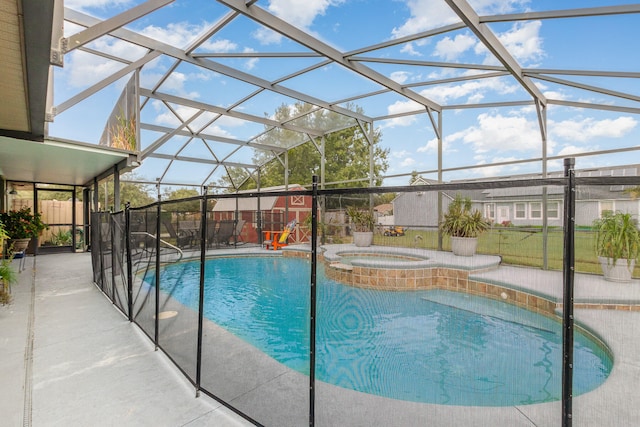 view of swimming pool featuring an in ground hot tub, glass enclosure, and a patio area