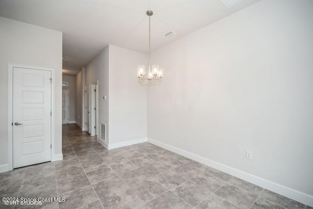 empty room with a notable chandelier