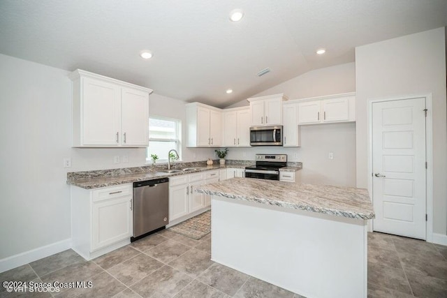 kitchen with a kitchen island, white cabinetry, and stainless steel appliances