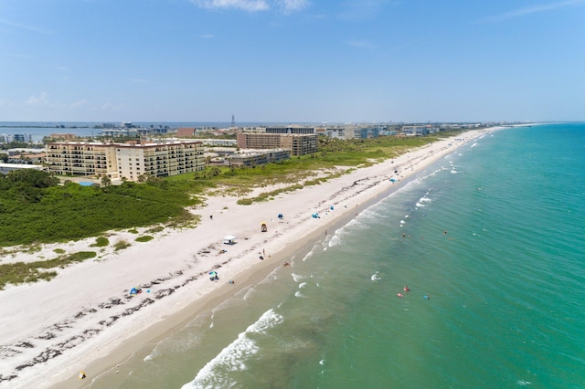 drone / aerial view featuring a water view and a view of the beach