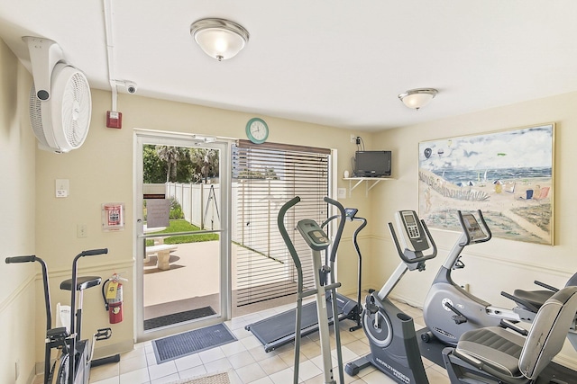 exercise room with light tile flooring