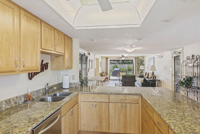 kitchen with light brown cabinetry, ceiling fan, sink, dishwasher, and light stone countertops