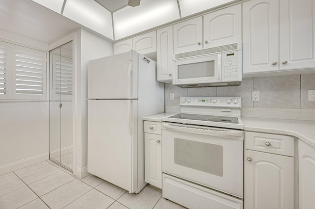 kitchen featuring backsplash, white appliances, white cabinets, and light tile floors