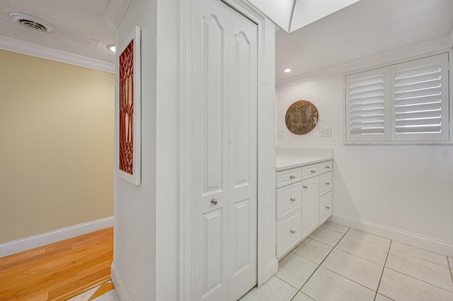 bathroom with vanity, a textured ceiling, tile floors, and ornamental molding