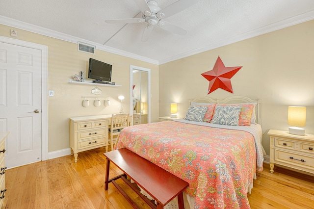 bedroom featuring ornamental molding, a textured ceiling, ceiling fan, and light hardwood / wood-style flooring