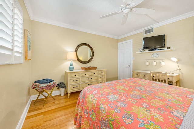 bedroom with light hardwood / wood-style floors, ornamental molding, and ceiling fan