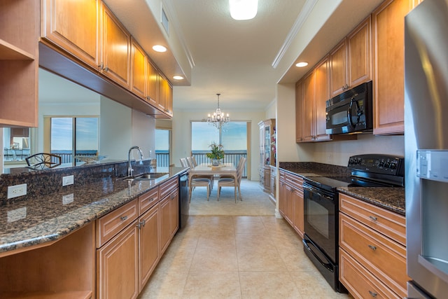 kitchen featuring black appliances, an inviting chandelier, sink, dark stone counters, and pendant lighting