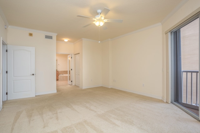 carpeted spare room featuring ceiling fan and crown molding