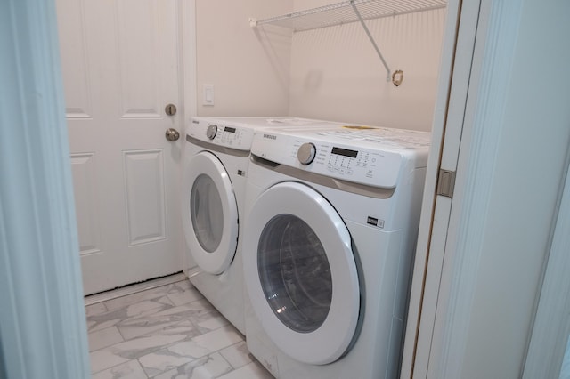 washroom with light tile floors and washing machine and clothes dryer