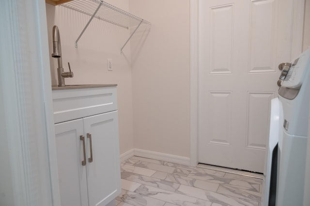 laundry room with light tile flooring and washer / dryer