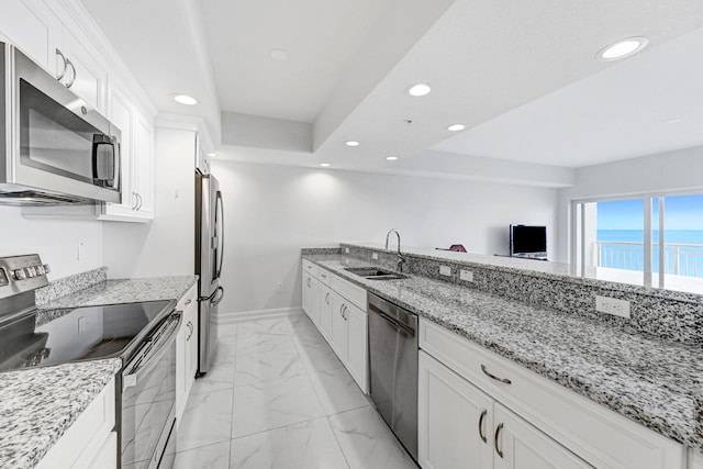 kitchen with sink, light tile floors, light stone counters, white cabinets, and appliances with stainless steel finishes