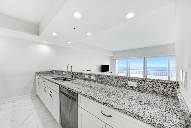 kitchen featuring light stone countertops, white cabinets, a water view, dishwasher, and sink