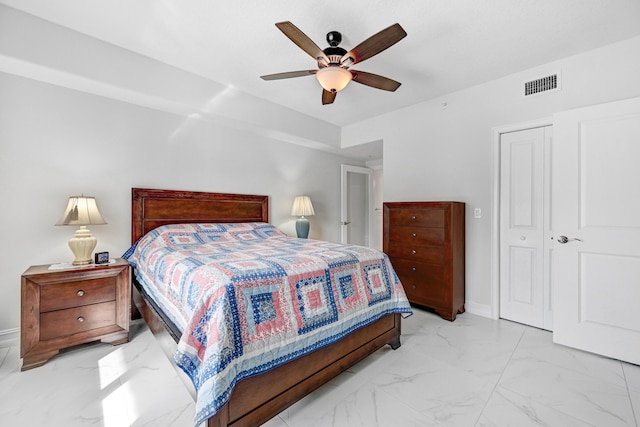 tiled bedroom featuring a closet and ceiling fan