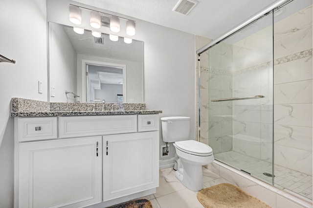 bathroom featuring toilet, a shower with door, tile flooring, a textured ceiling, and vanity