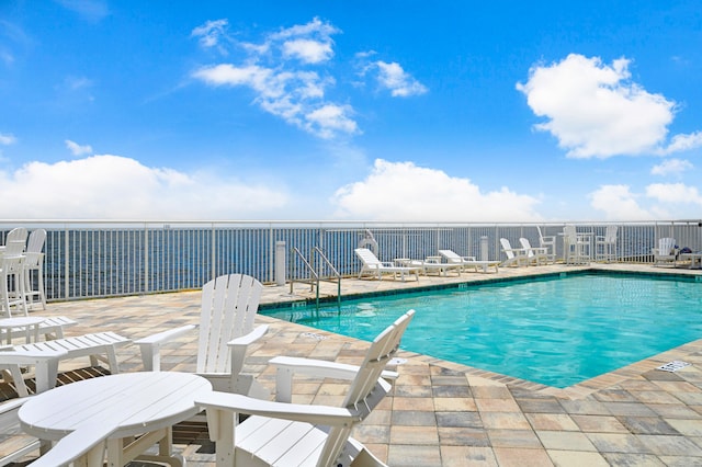 view of swimming pool featuring a patio area