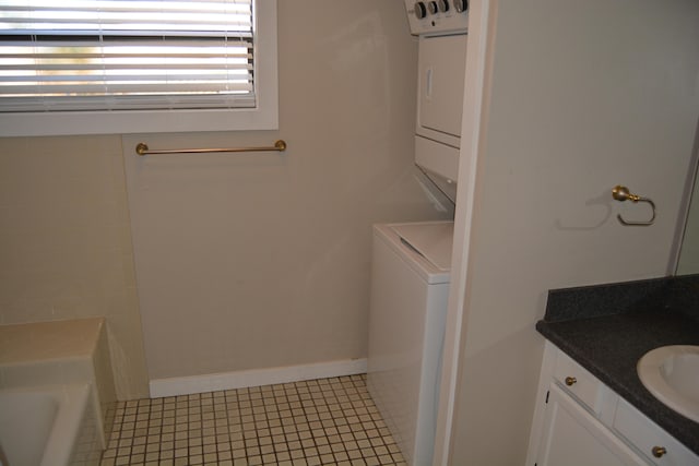 washroom with stacked washer and clothes dryer, tile floors, and sink