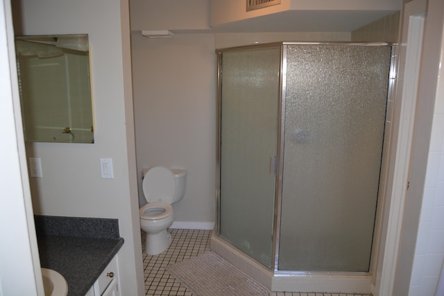 bathroom with toilet, tile floors, an enclosed shower, and vanity