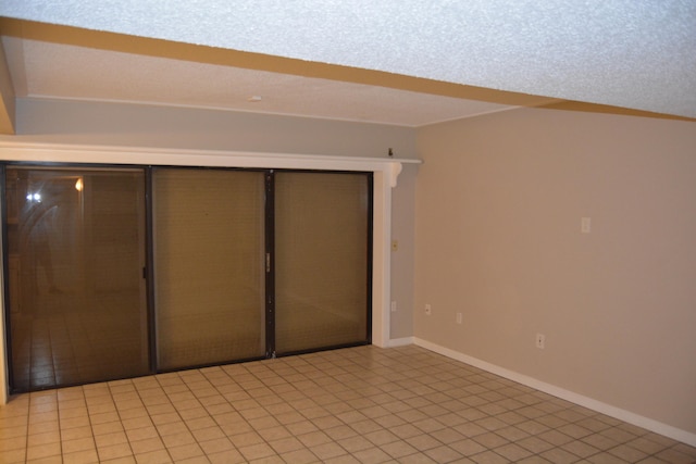 unfurnished bedroom with light tile flooring and a closet