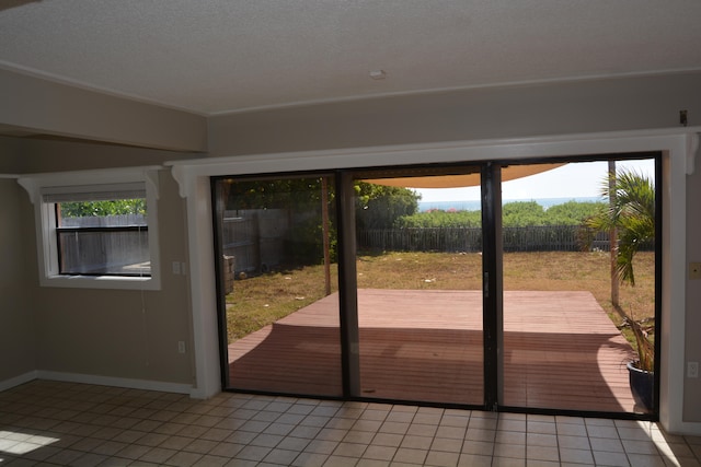 entryway featuring a textured ceiling and light tile floors