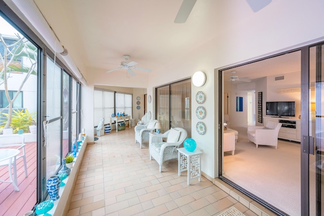 sunroom featuring ceiling fan