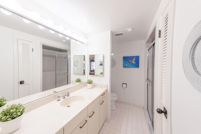 bathroom featuring toilet, tile floors, and oversized vanity