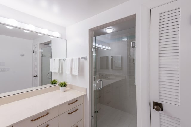 bathroom with an enclosed shower and vanity