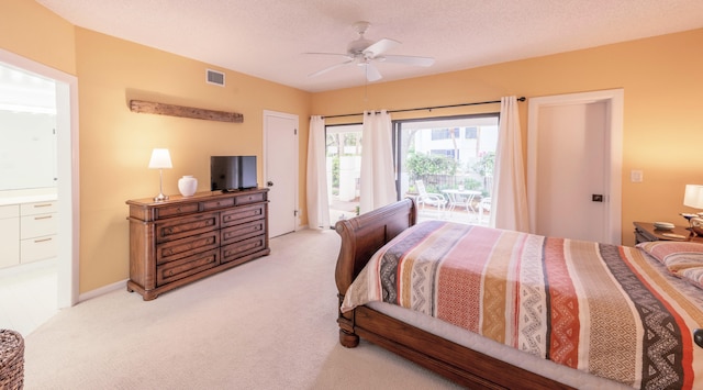 carpeted bedroom featuring connected bathroom, a textured ceiling, access to outside, and ceiling fan