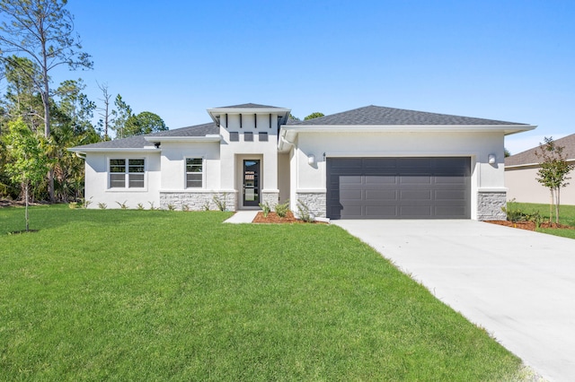 prairie-style house featuring a garage and a front yard